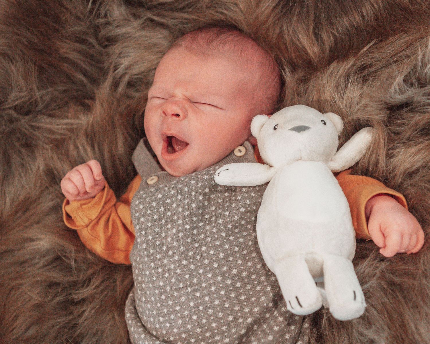 New born at home photo shoot with Cornwall new born photographer baby yawning