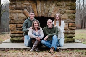 family photo in front of outdoor fireplace