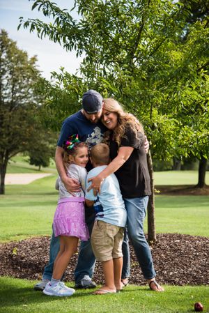 family photo with two kids lots of hugs