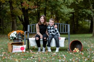 fall sibling photo on bench with leaves