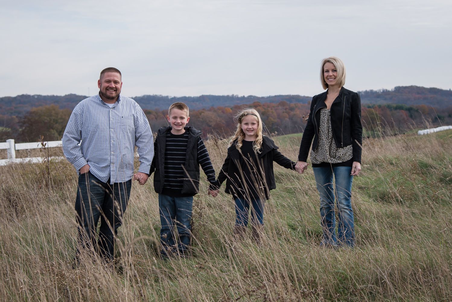 family with two kids in open field