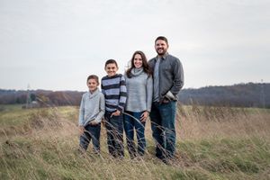 family photo open field with two kids