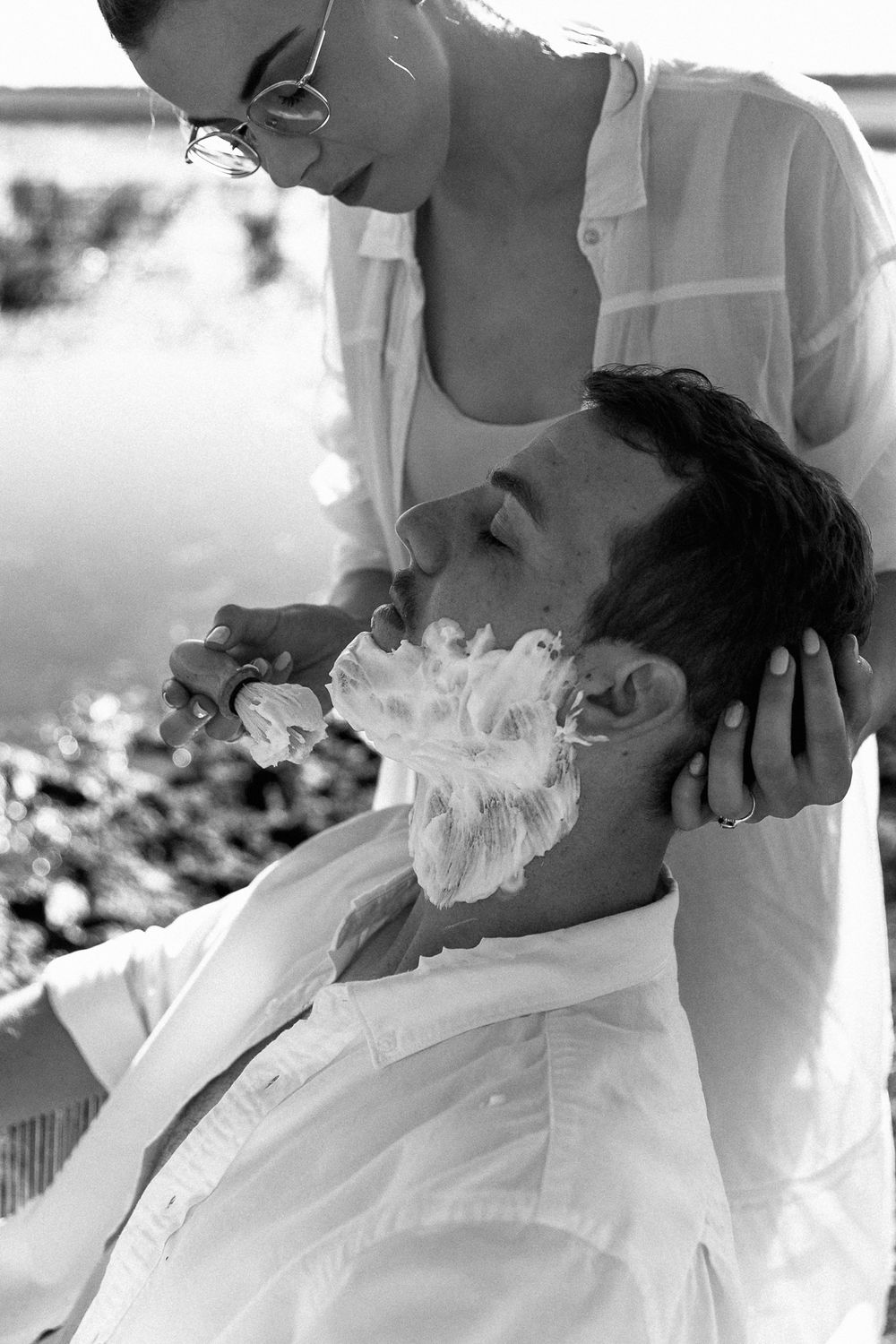 Tharine shaving Frans during thier anniversary photos by Dust and Dreams Photography.
