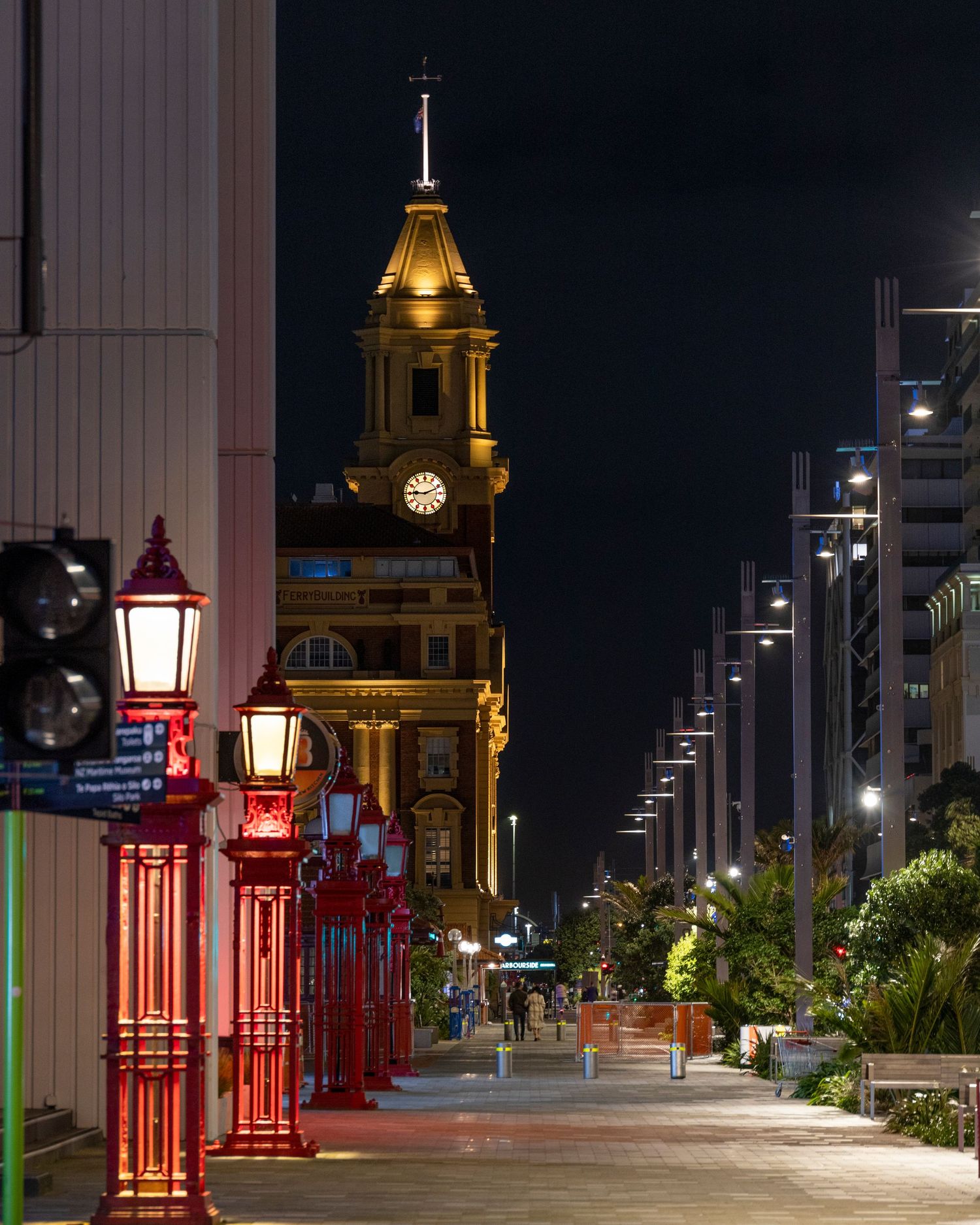 Red lanterns line the way to Dunedin’s grand old post office, glowing against a calm night sky.