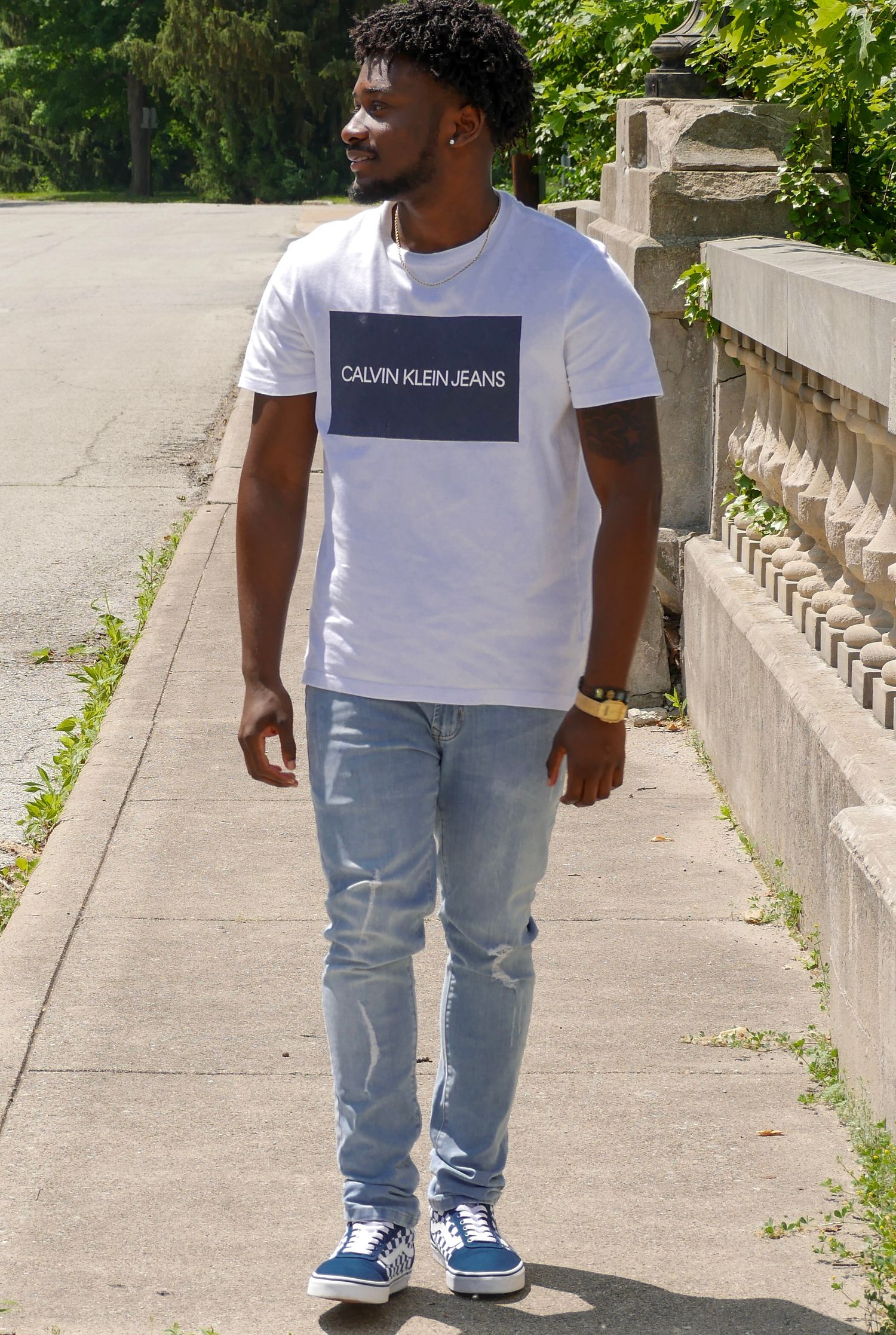 Casual street style photo of model in Calvin Klein t-shirt and light denim.