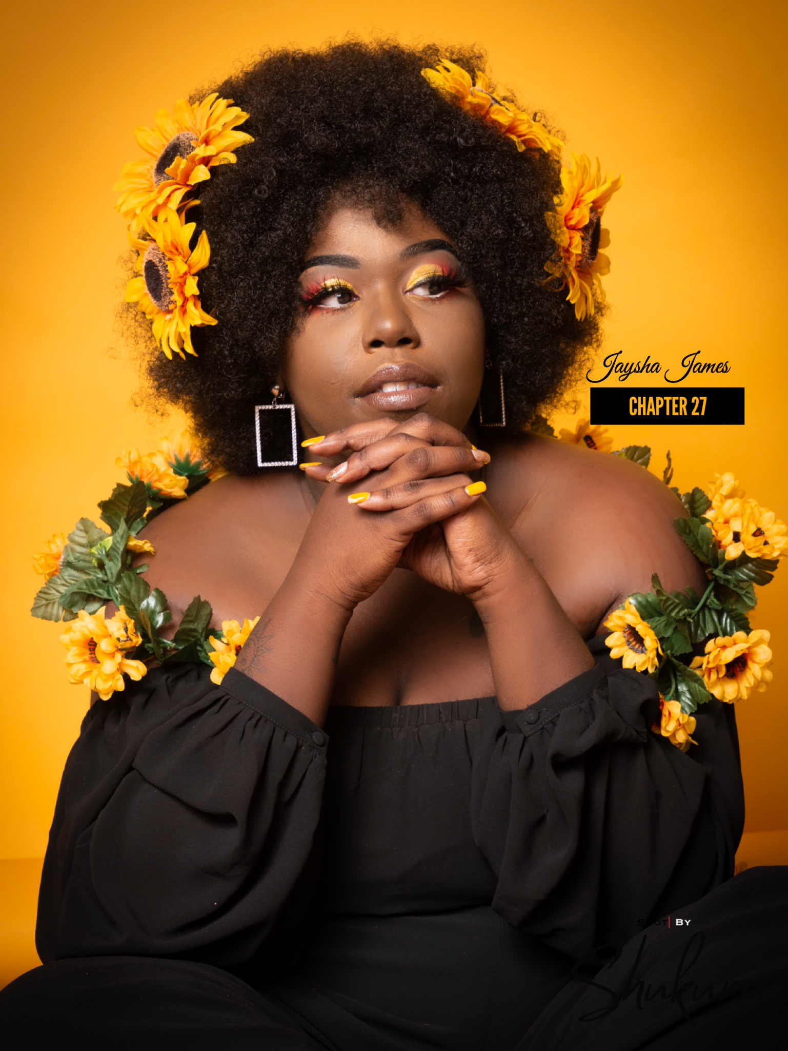 Artistic portrait with sunflowers against warm orange background in dramatic lighting.