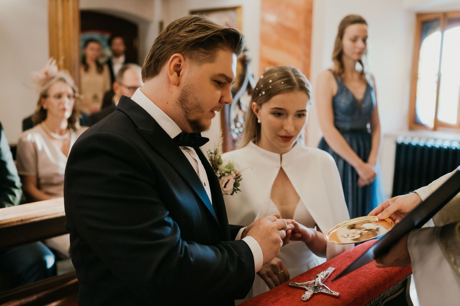 A couple signs documents during their traditional Catholic church wedding ceremony.