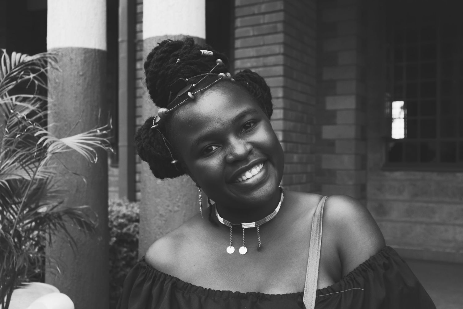 a black and white african woman smiling during an event photography