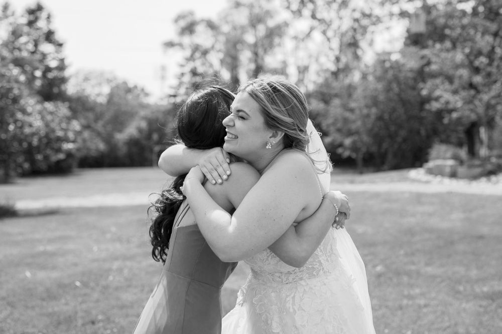 Tender embrace captured in black and white outdoor photography.