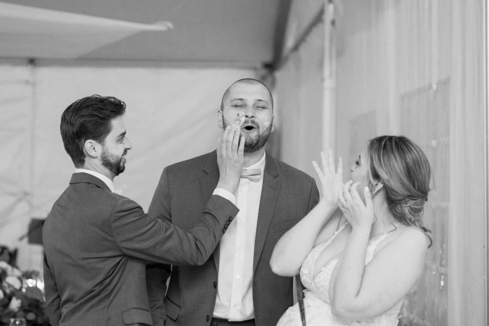 Wedding party shares candid laughing moments during outdoor photo session.