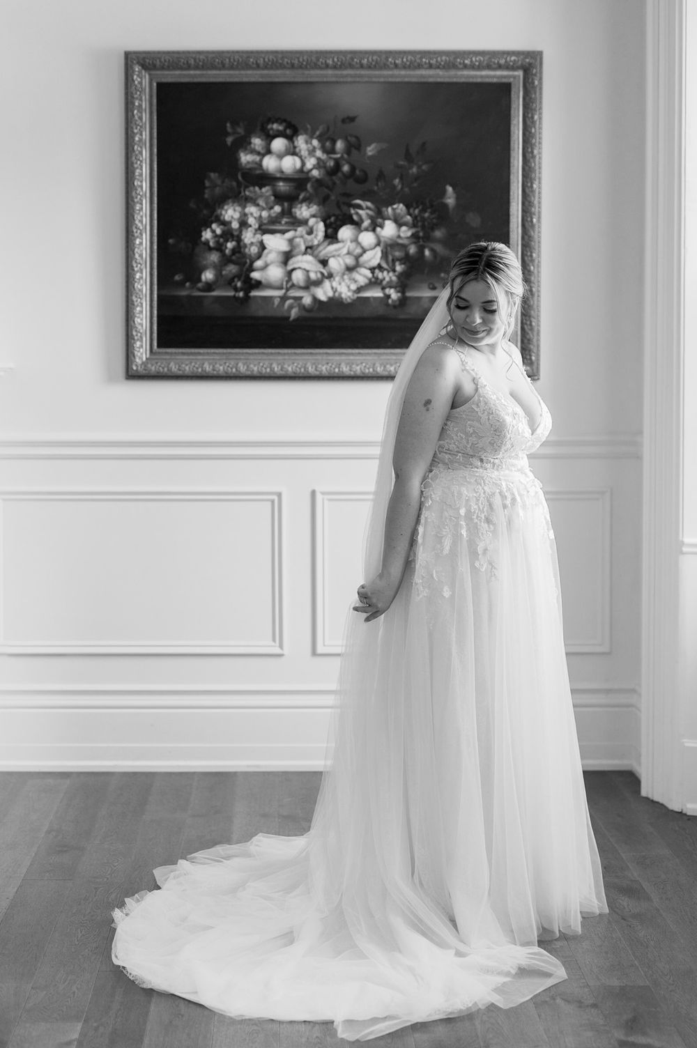 Elegant bridal portraits showcasing a flowing white wedding gown in a classic interior setting.