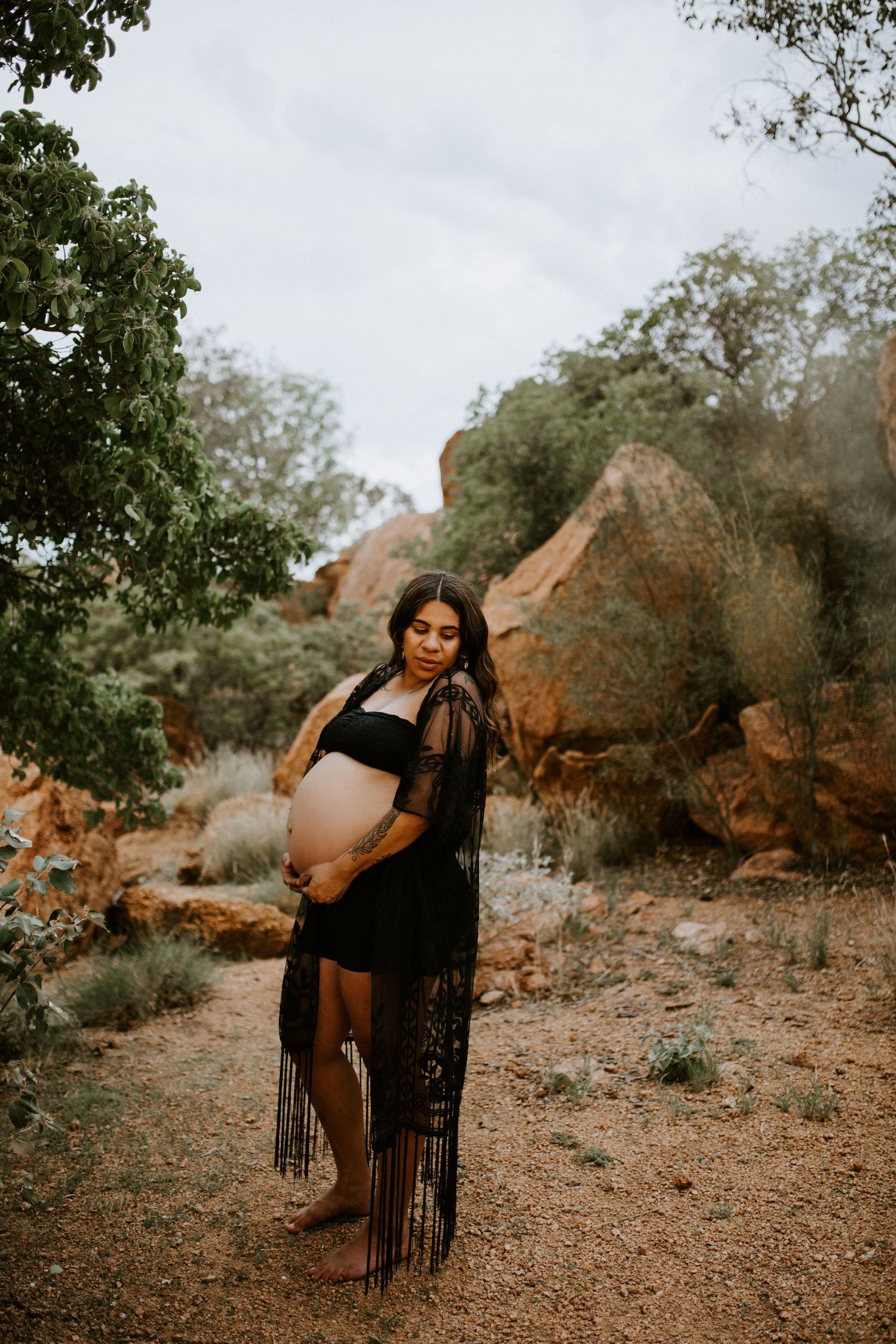 Image of mama to be standing amongst boulders at Granite Mines Mount Isa