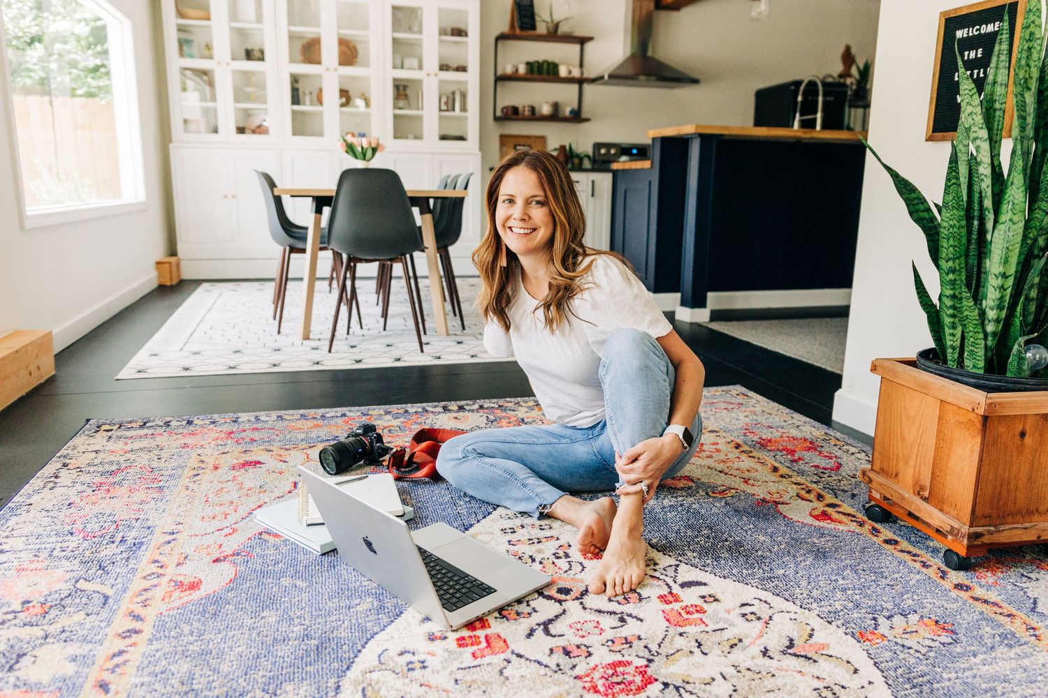 woman sitting on floor and working at her laptop for branding photos