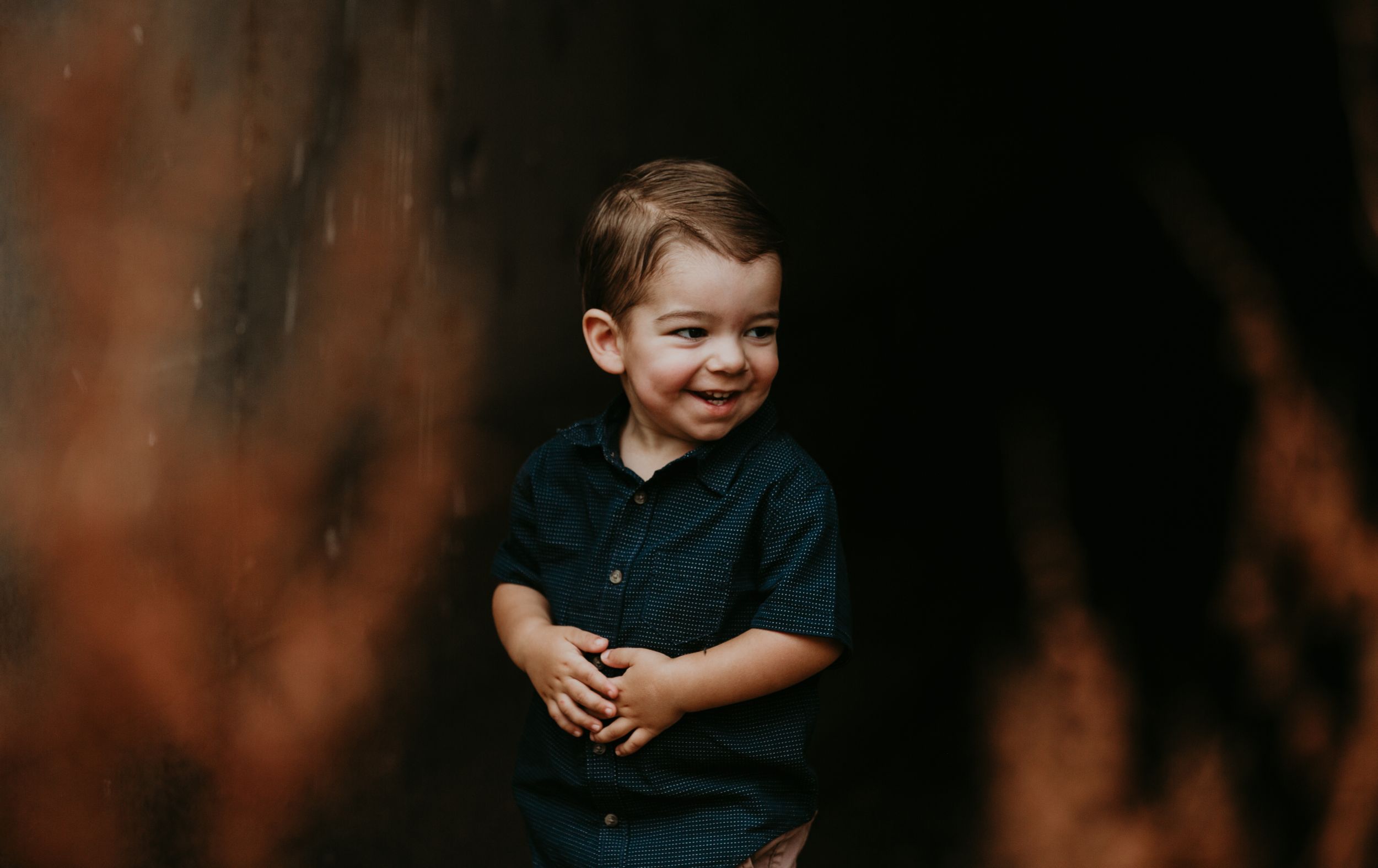 Dark moody portrait session with dramatic lighting and shadows.