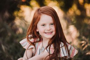 Outdoor portrait capturing genuine smiles and laughter in warm golden light.