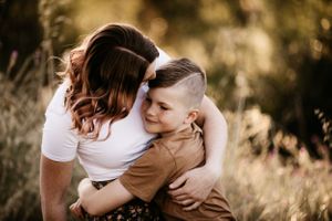 Natural family interactions captured in warm evening light outdoors.