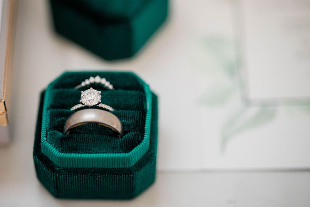 Diamond engagement ring in an emerald green velvet box.