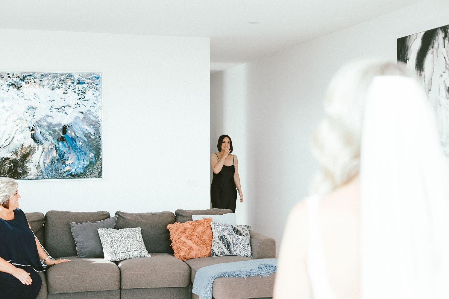 Stylish living room featuring a gray sectional sofa and coastal artwork.