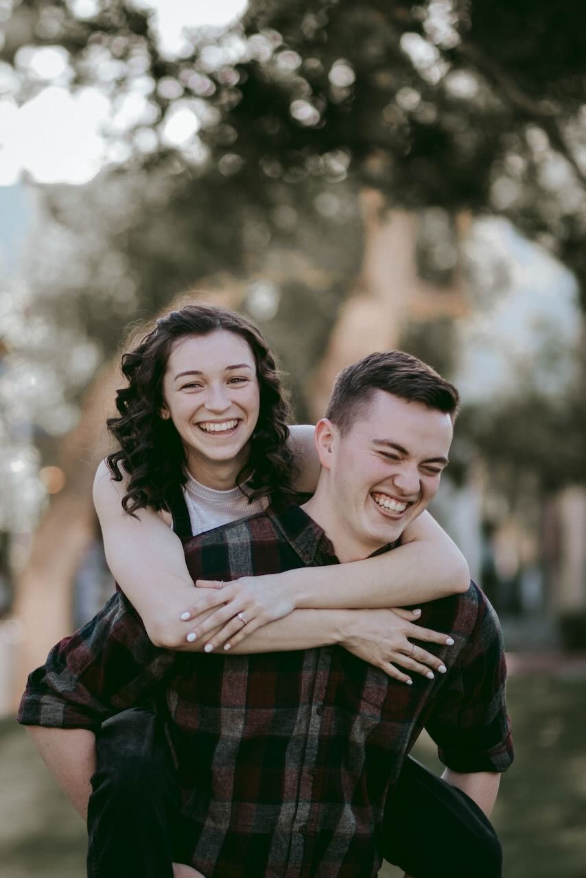 Newly engaged couple embracing in a Snohomish field. Intimate and affectionate engagement photography by Tim Neal.