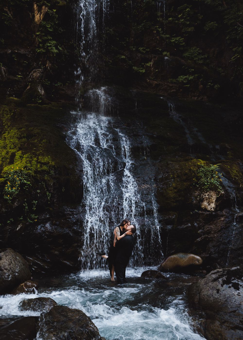 Sweet kiss between a newly engaged couple in a waterfall Snohomish park. Tim Neal Photography.