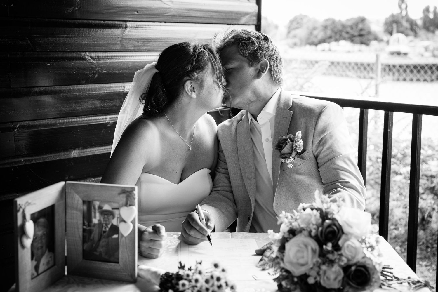 Intimate black and white wedding photo with table decorations and flowers.