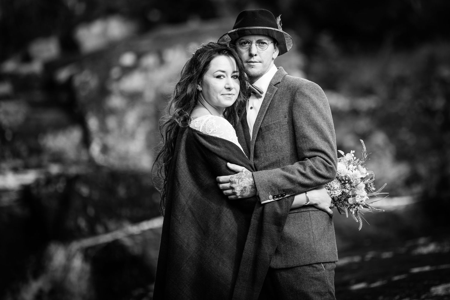 A black and white portrait capturing a romantic moment in nature.