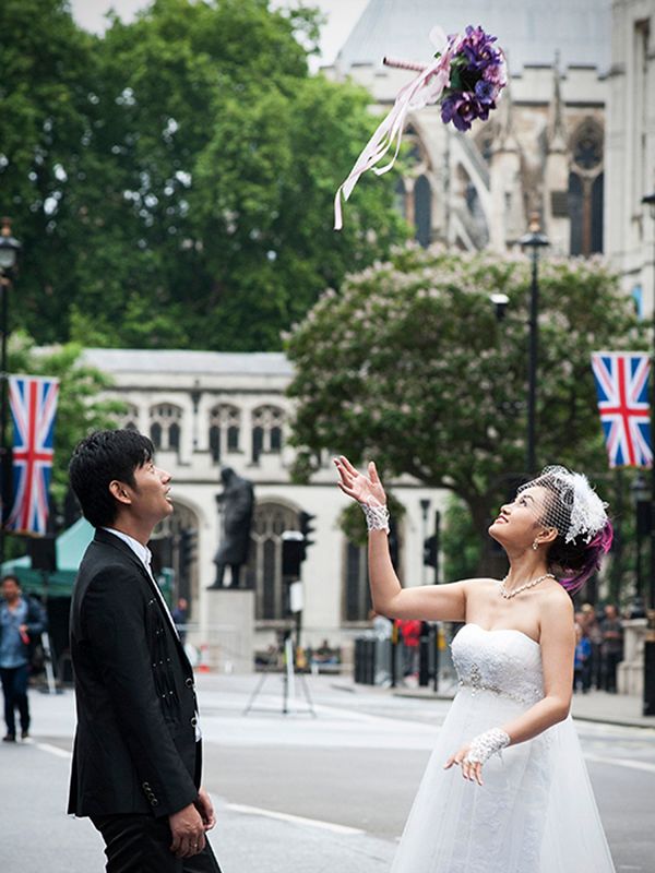 Japanese Bride and Groom throw the wedding bouquet, reportage photography central London.