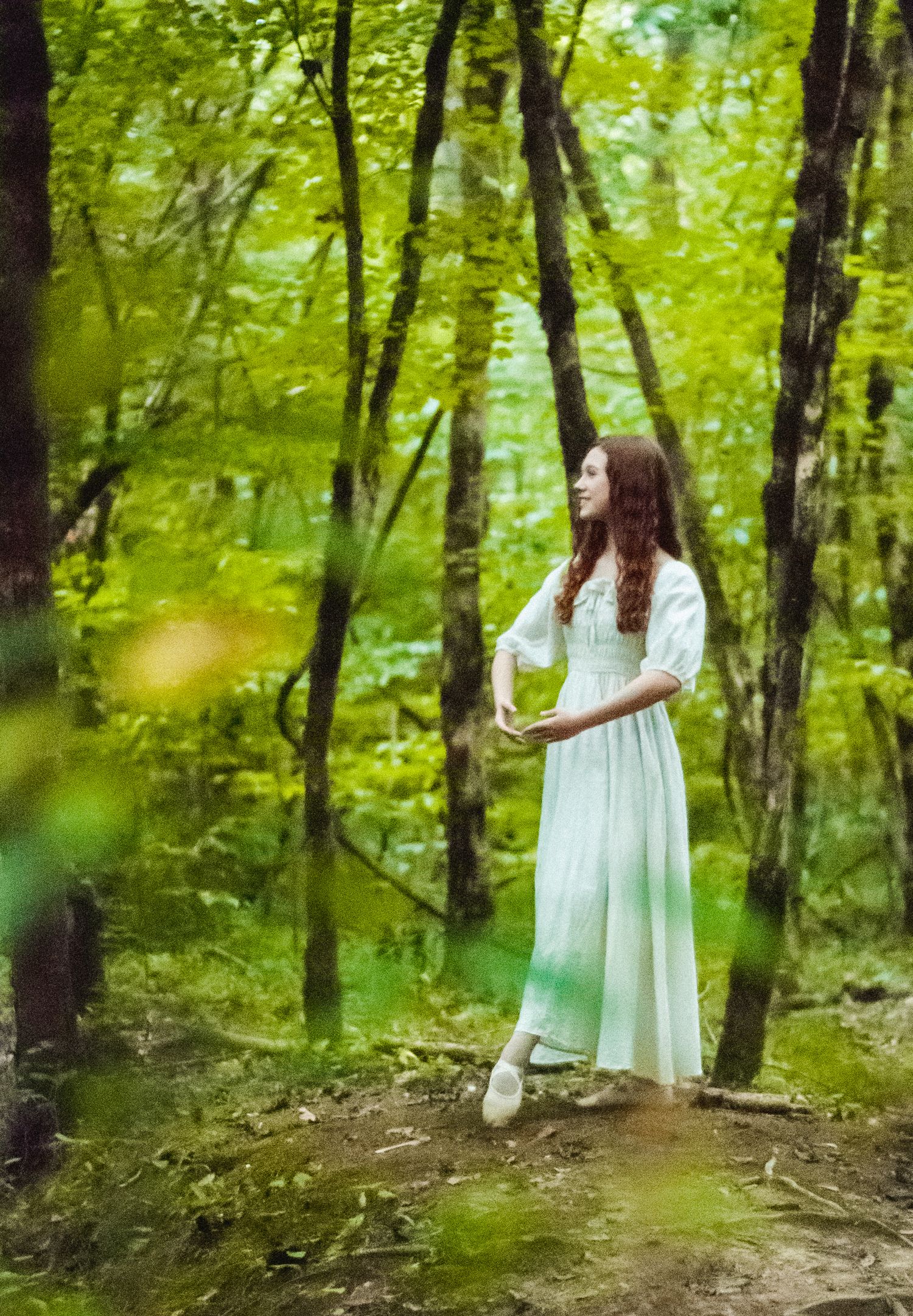 Woman in forest striking a simple dance pose in Fort Mill, South Carolina