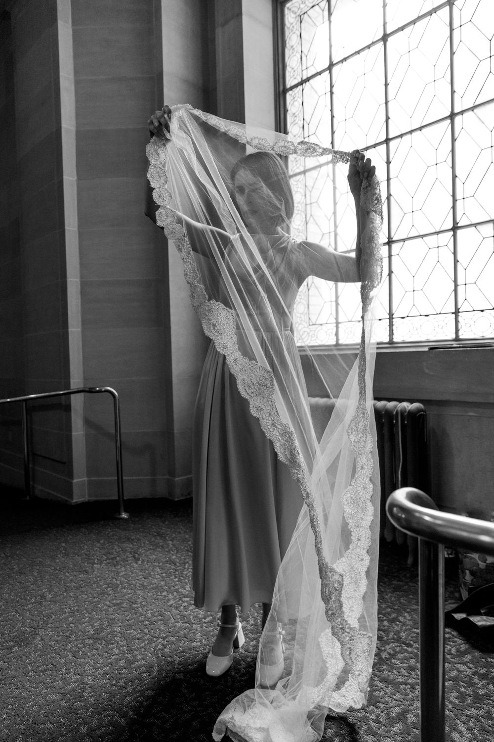 bride putting on her veil at San Francisco city hall