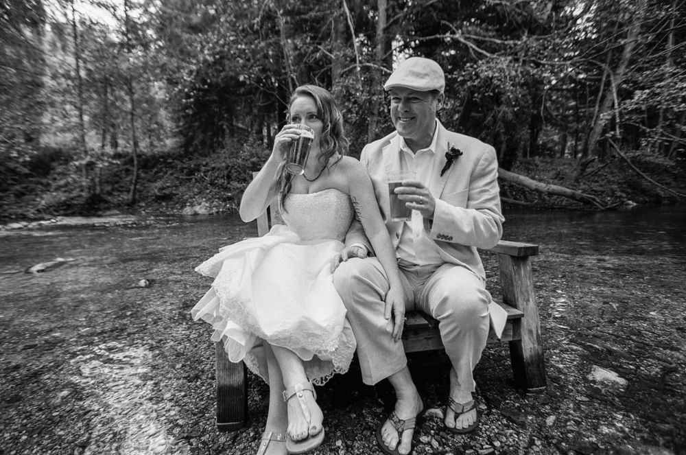 Bride and Groom enjoying a drink at the Big Sur Inn in the river