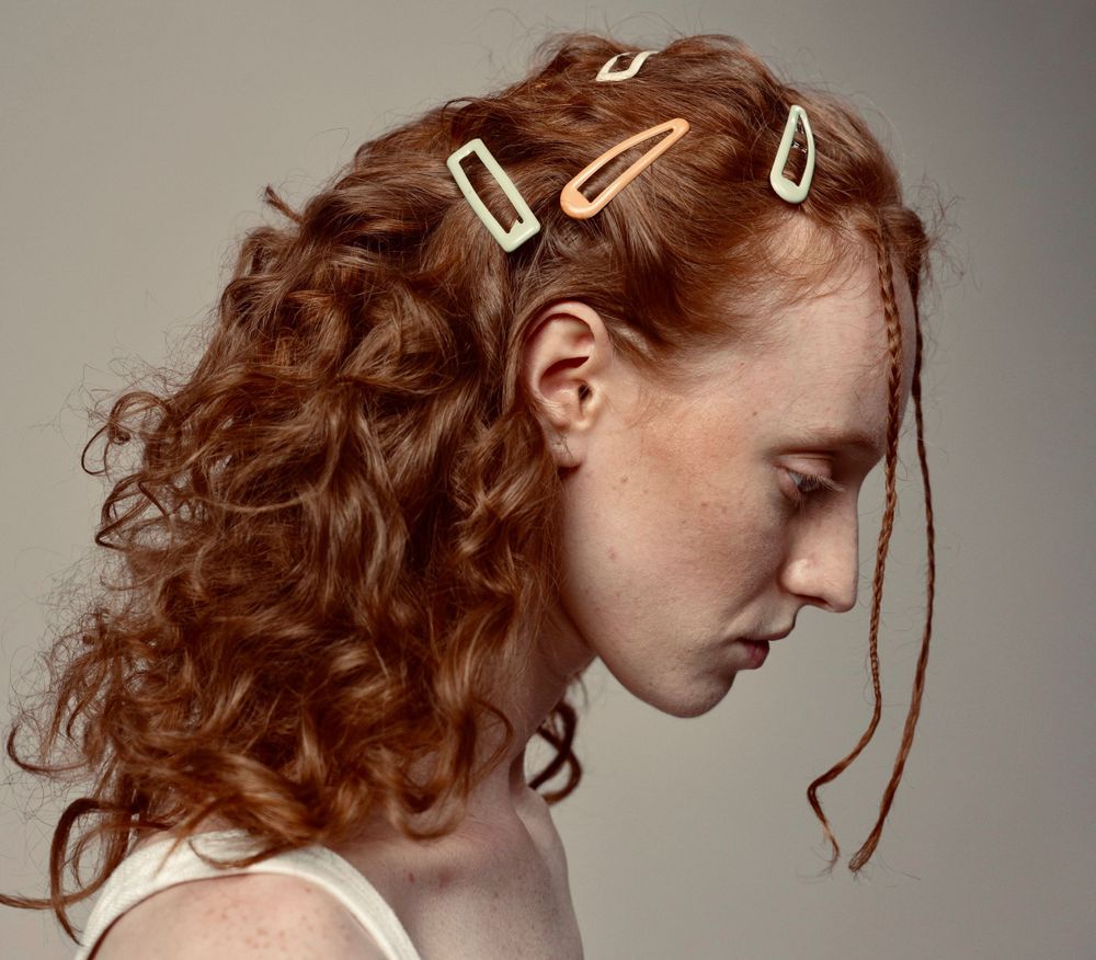 Strongshot Studio, Martinez, GA, Creative Photography, side portrait of woman with many hair clips on her head.