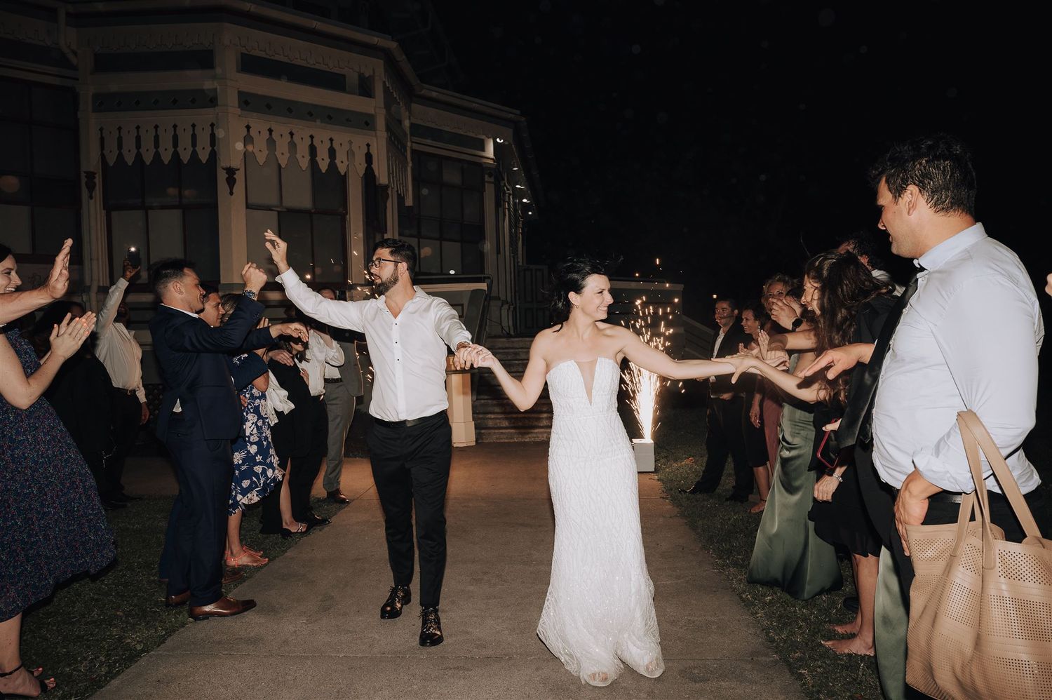 Wedding guests form a tunnel of sparklers as the couple makes their grand exit.