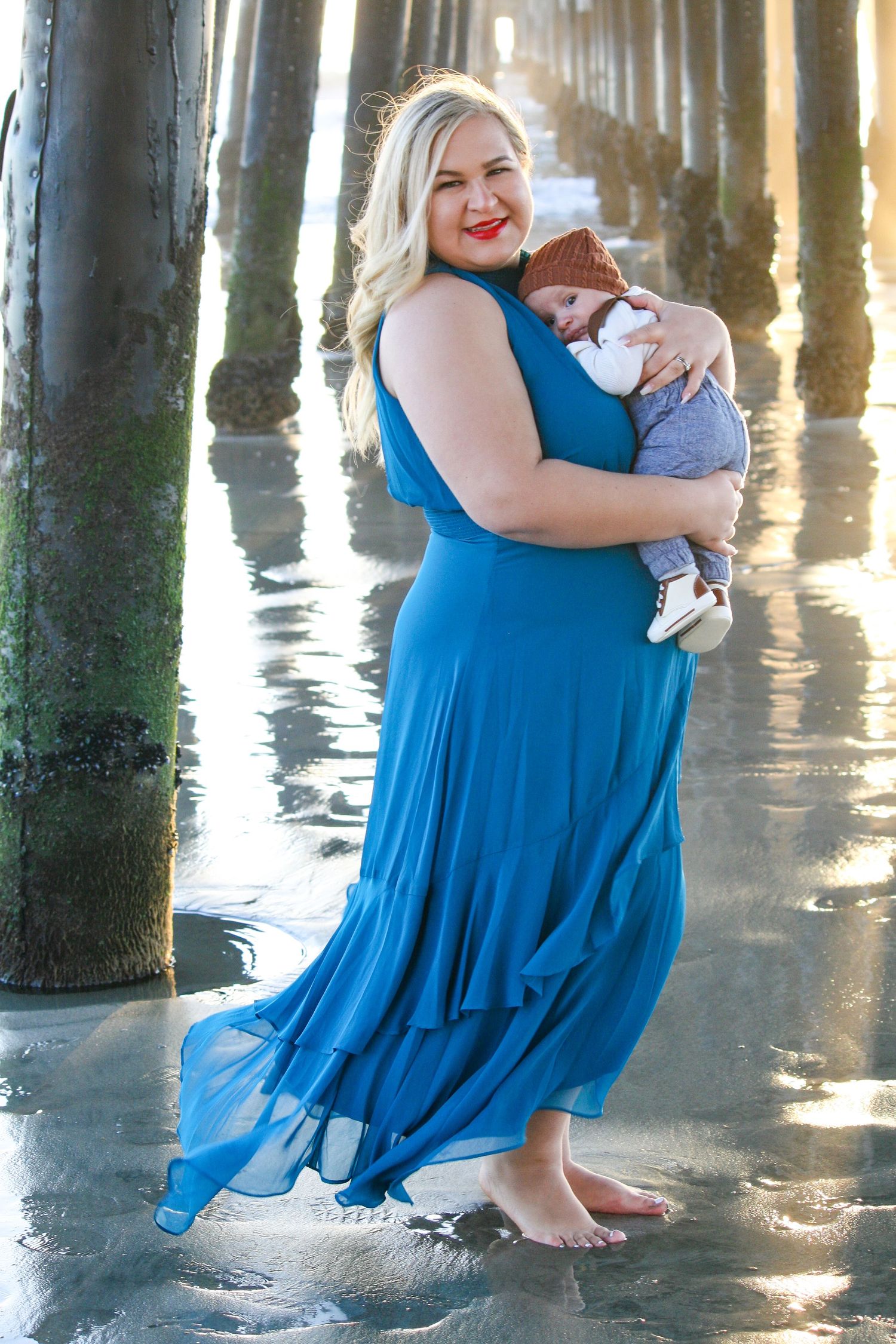 mom and baby at the ocean pier during sunset
