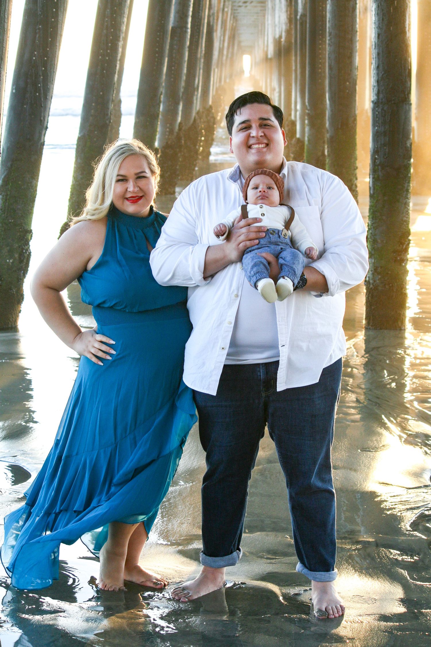 family photo by the ocean pier during sunset