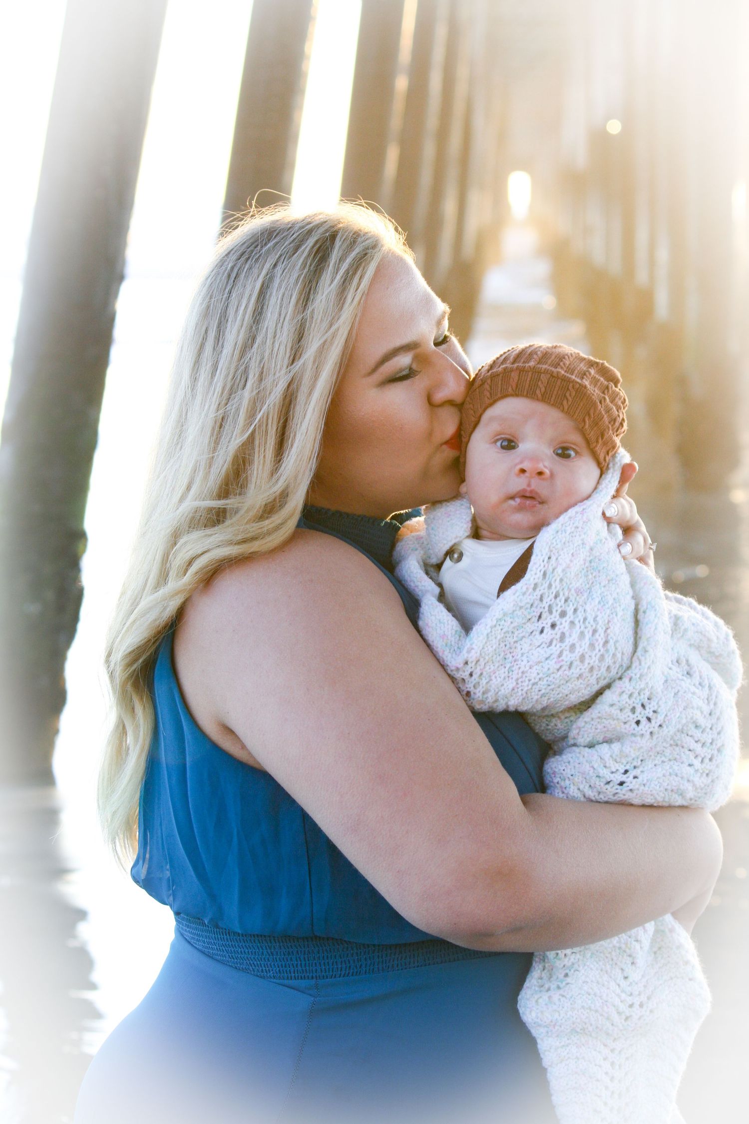 mom and baby photo at the ocean pier