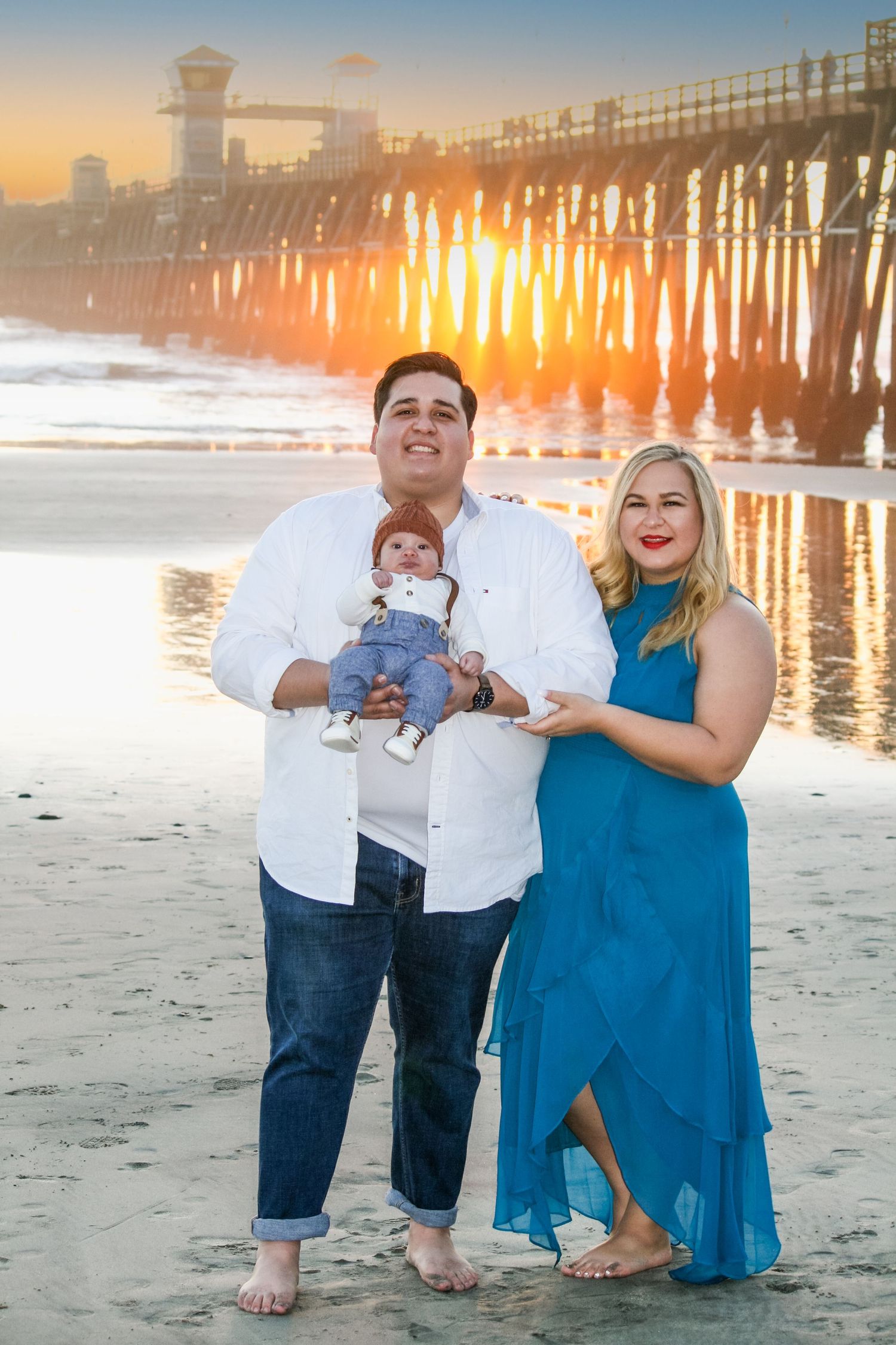 family photo at the ocean pier during sunset