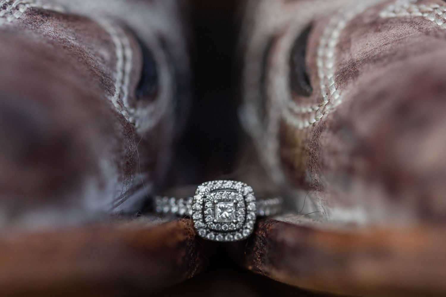 Close-up detail shot of a diamond engagement ring with double halo design.