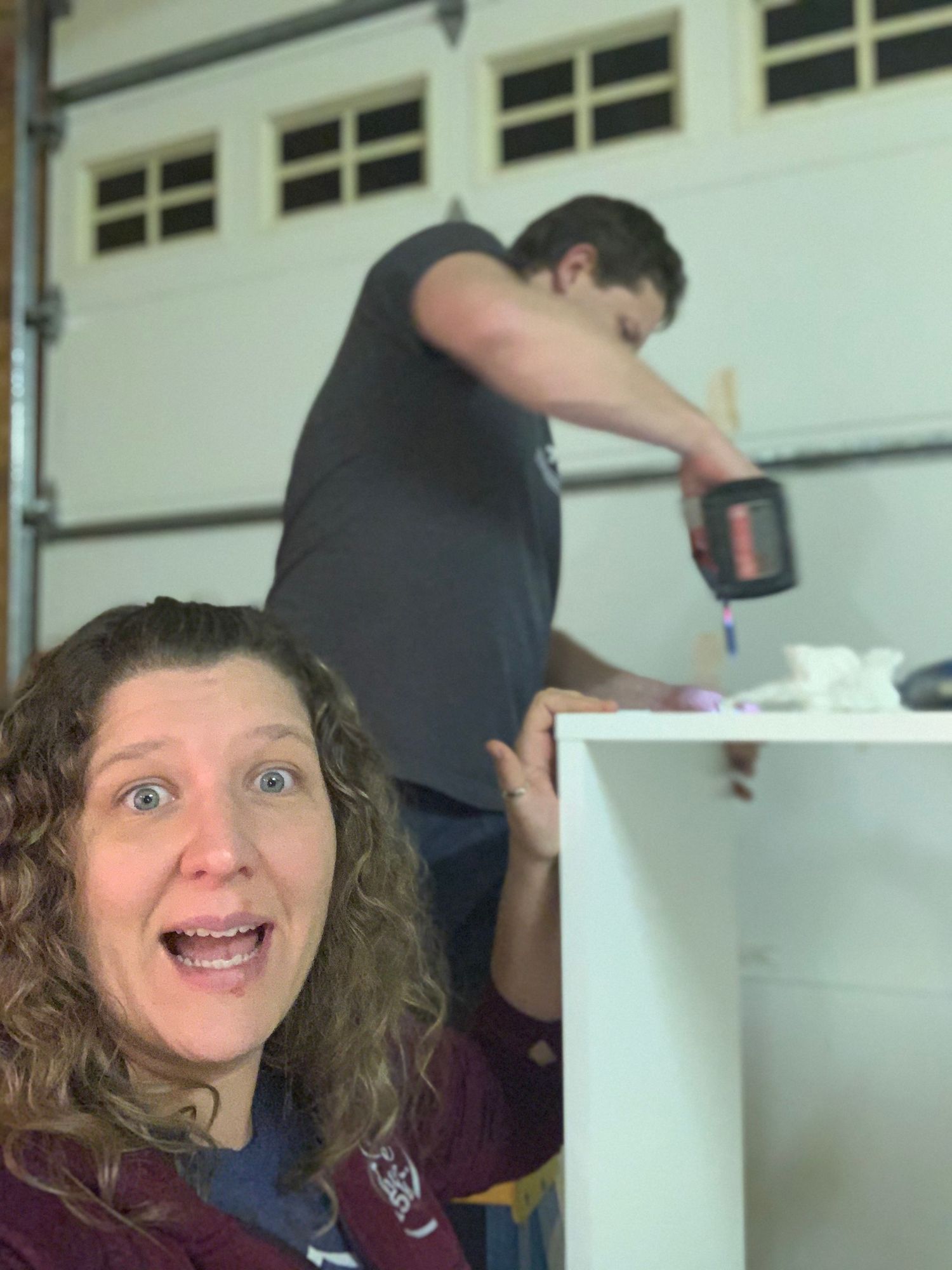 Behind-the-scenes photo of furniture assembly in a garage or workshop setting.