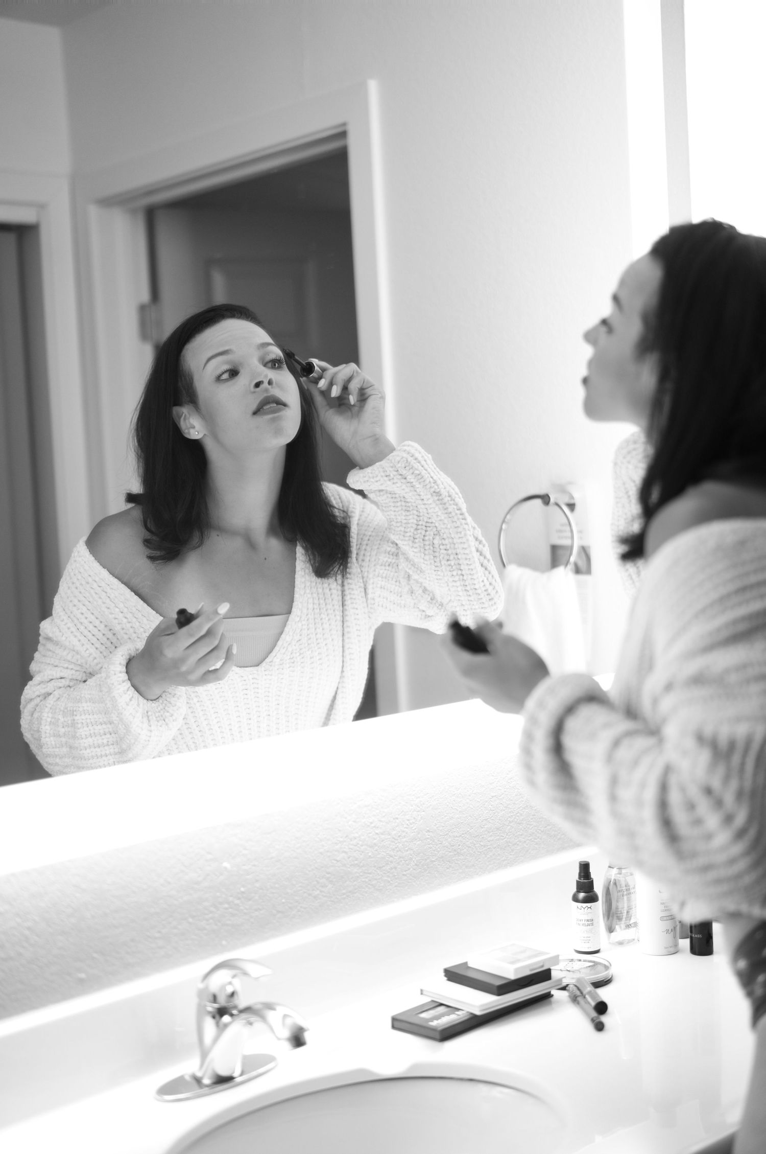 A boudoir photography session featuring intimate poses in a dimly lit bath setting.