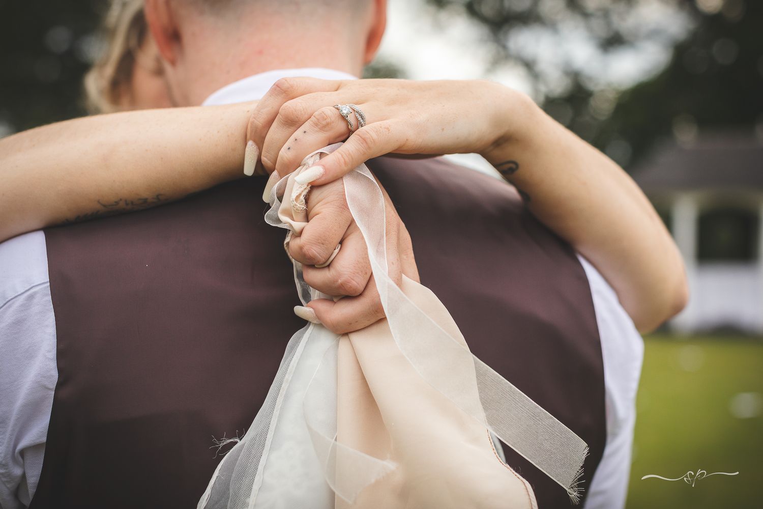 Couple embracing during a moment alone, beautiful wedding photography in Hampshire.