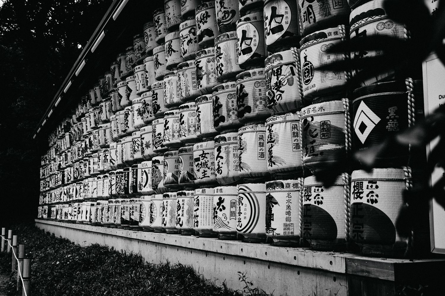 Black and white photograph of traditional Japanese paper lanterns lined up in rows.