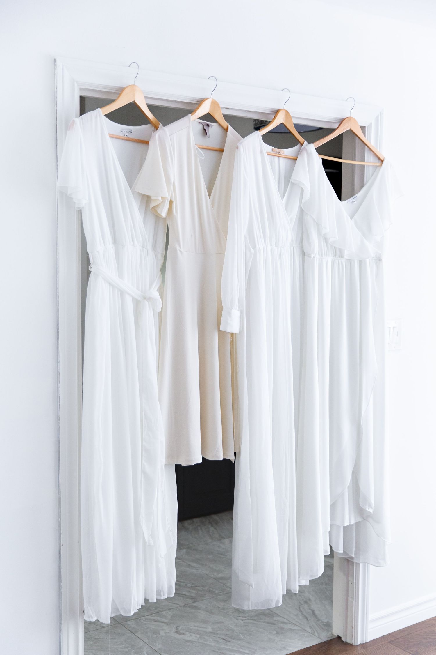 White women's dresses hanging in photo studio