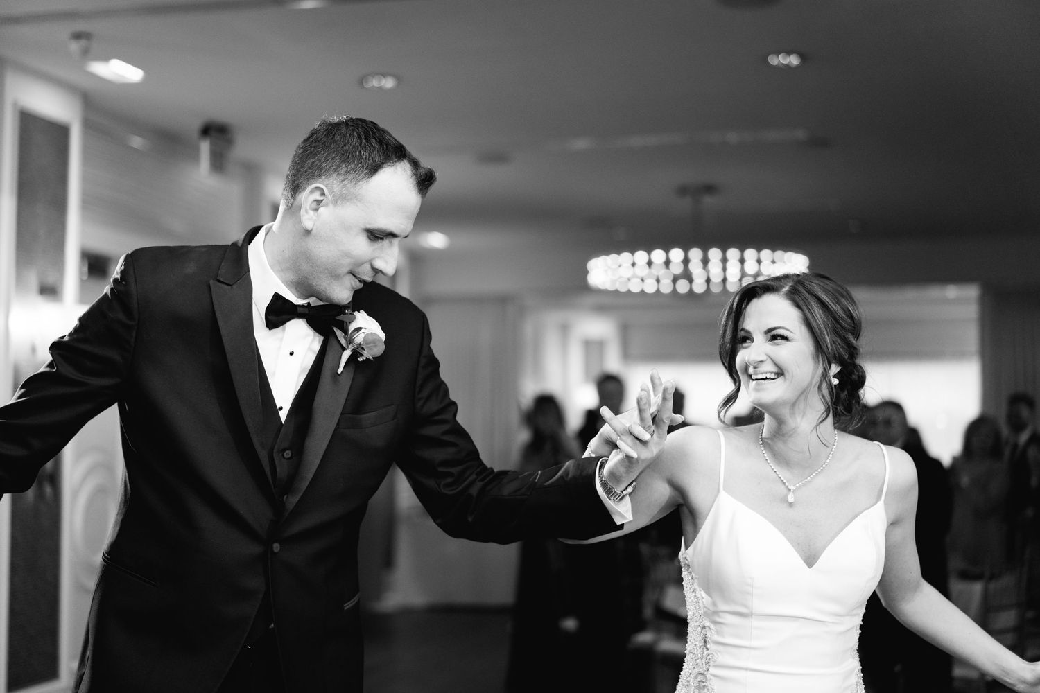 bride and groom enter reception the Piedmont ny winter wedding top floor black and white chrome