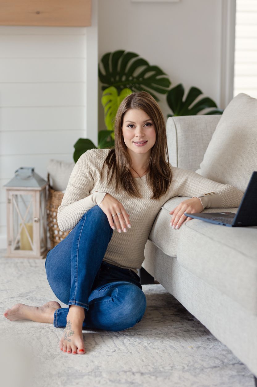 Environment portrait of a woman and her laptop on a couch