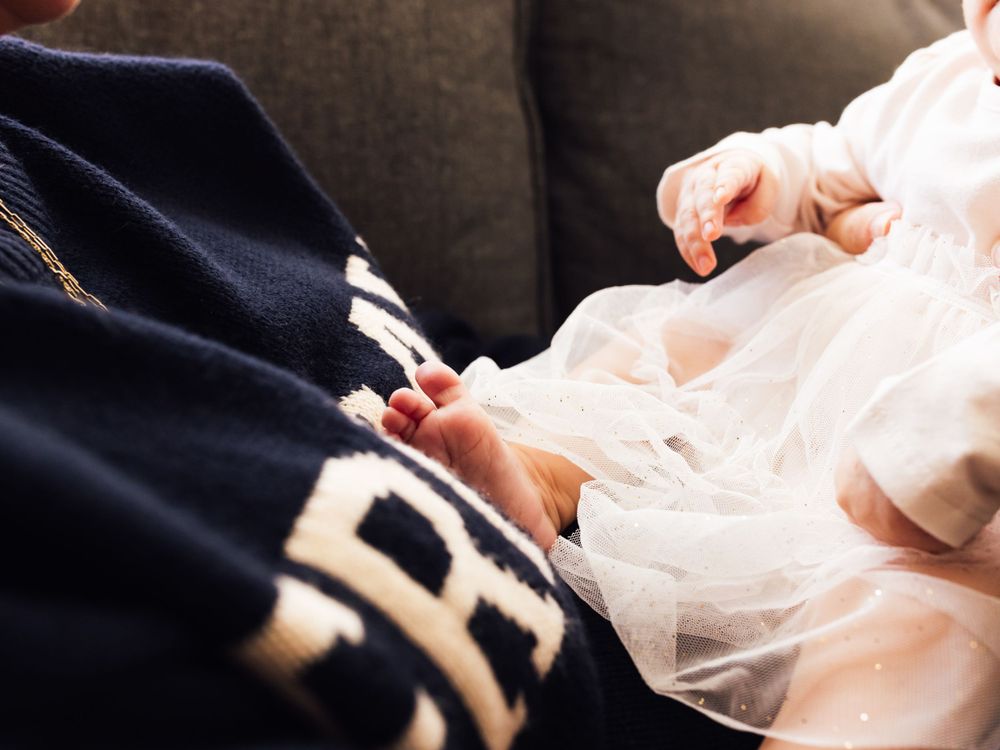 artistic lifestyle photography baby in pink dress with cute feet