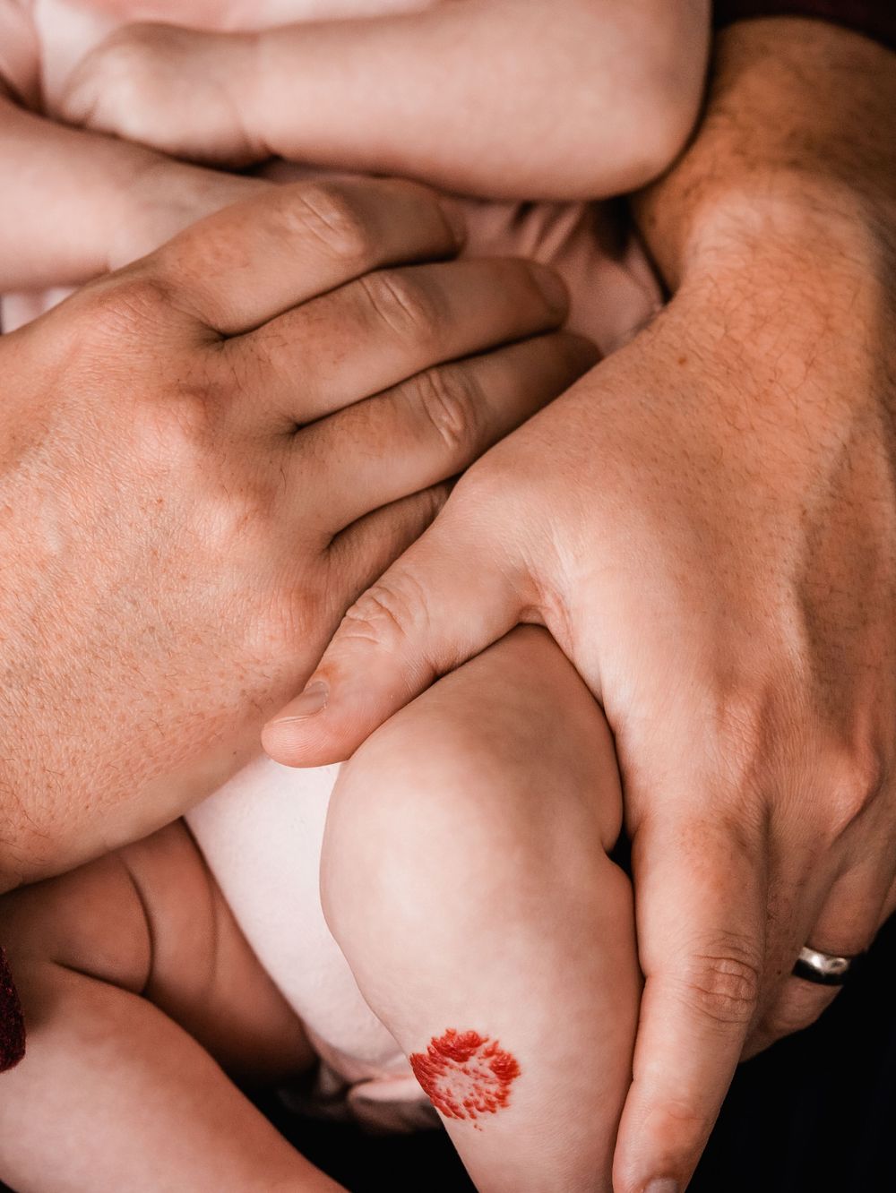 dads hands holding baby