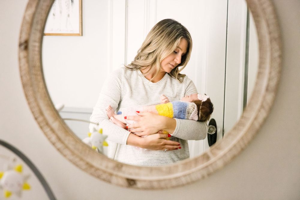 Infant Lifestyle session reflection of mother holding infant in mirror
