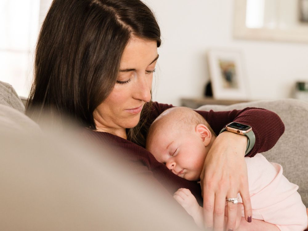 Lifestyle photo of mother and baby girl on couch
