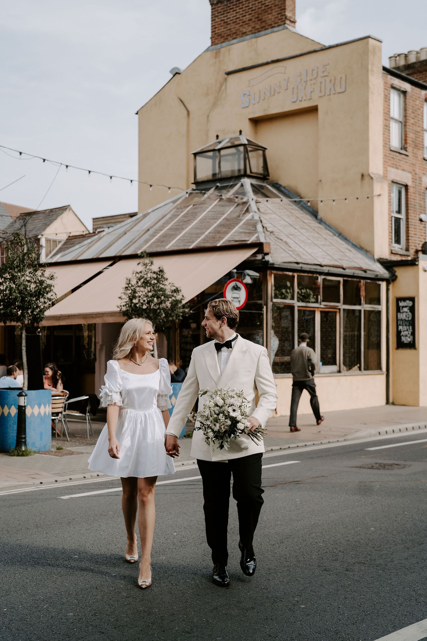 bride and groom crossing road in oxford
