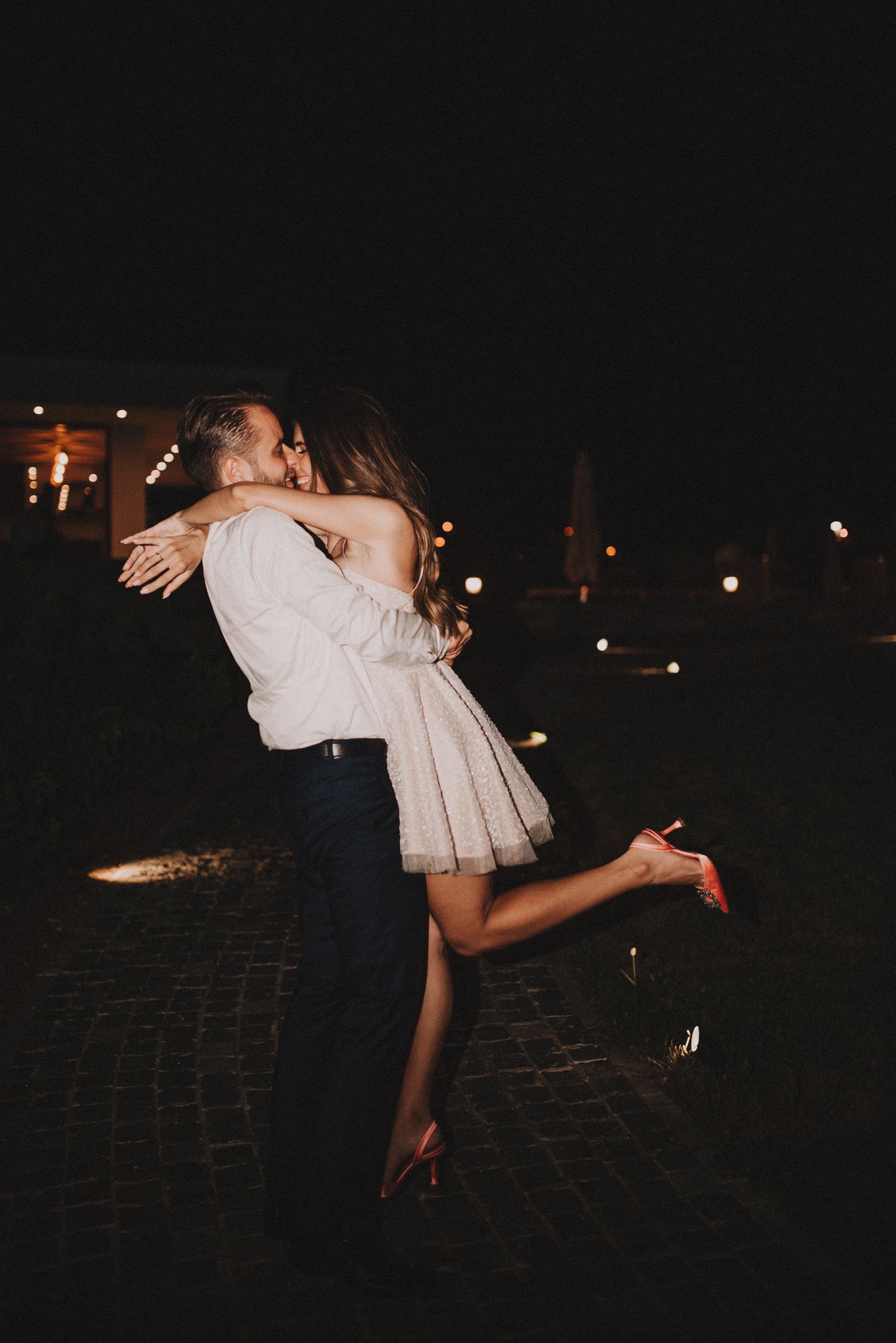 Carski Vinogradi Emporia at night and bride and groom in a hug.